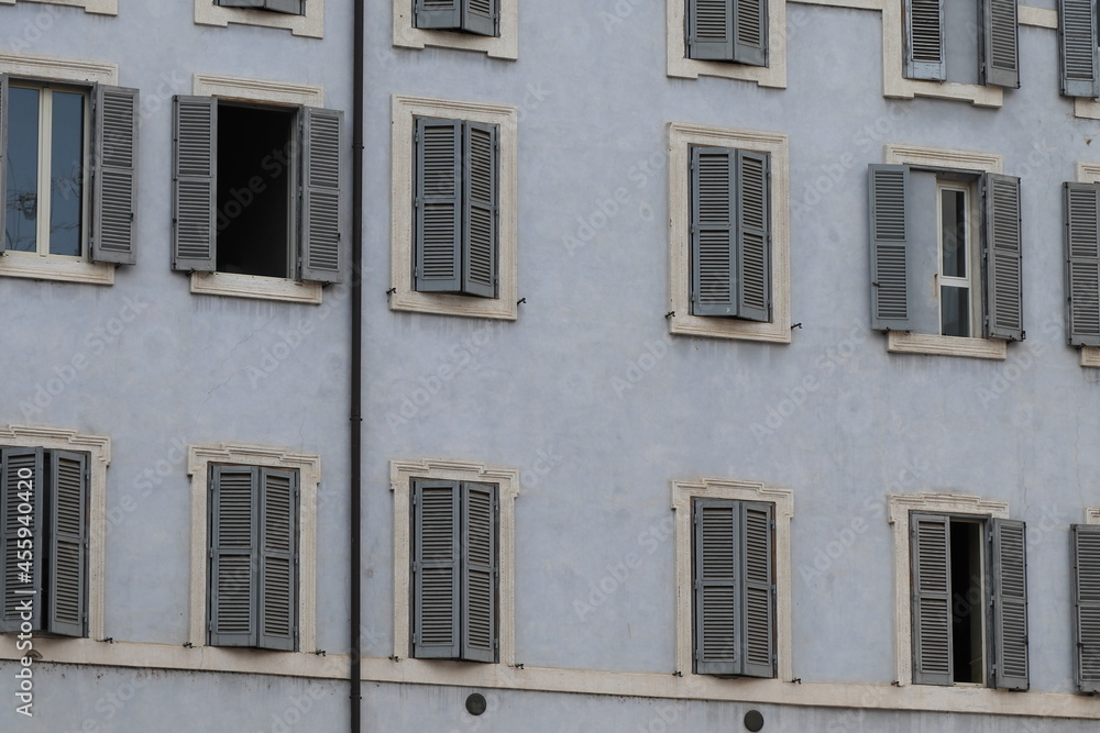 Light Blue Building Facade Detail with Windows and Shutters in Rome, Italy