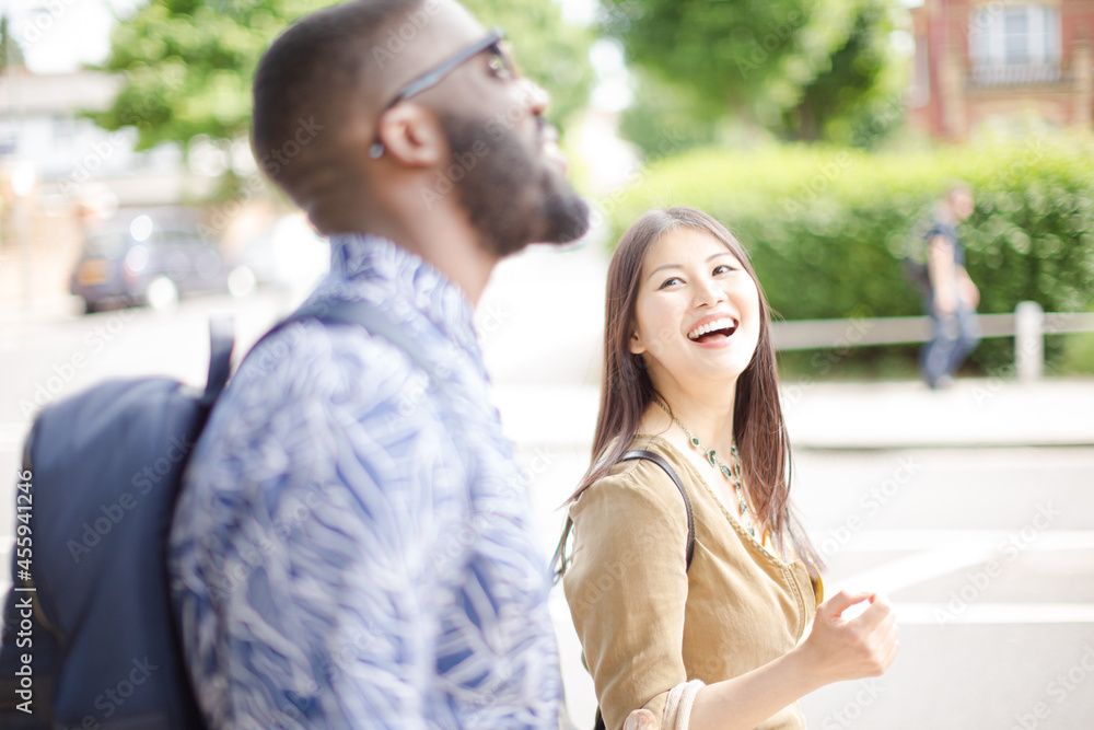 Young friends laughing on urban street