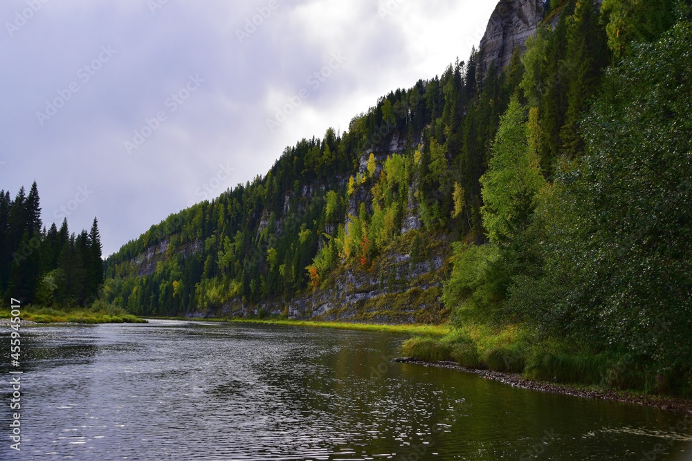 The Usva River, flowing at the foot of the Usvinskie Pillars rocks, becomes calm and deep