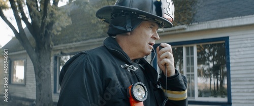 Фотография Firefighter chief talking on CB radio and giving orders to his crew, fireman fig