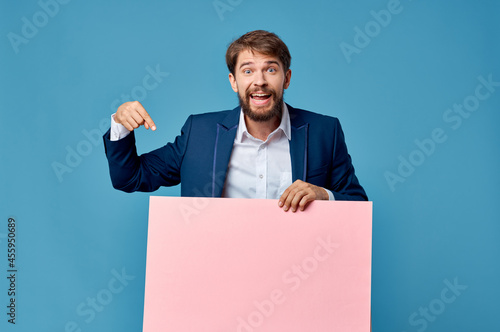 emotional man pink paper in the hands of marketing fun Lifestyle blue background