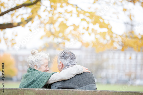 Wallpaper Mural Carefree, affectionate senior couple hugging on bench in autumn park Torontodigital.ca