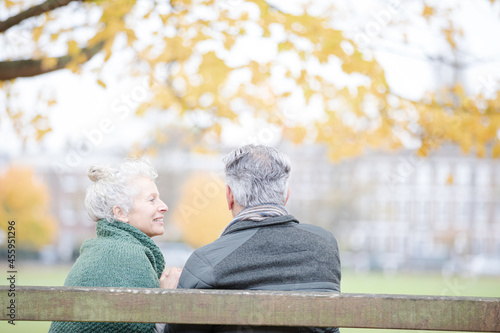 Wallpaper Mural Affectionate senior couple sitting on bench in autumn park Torontodigital.ca