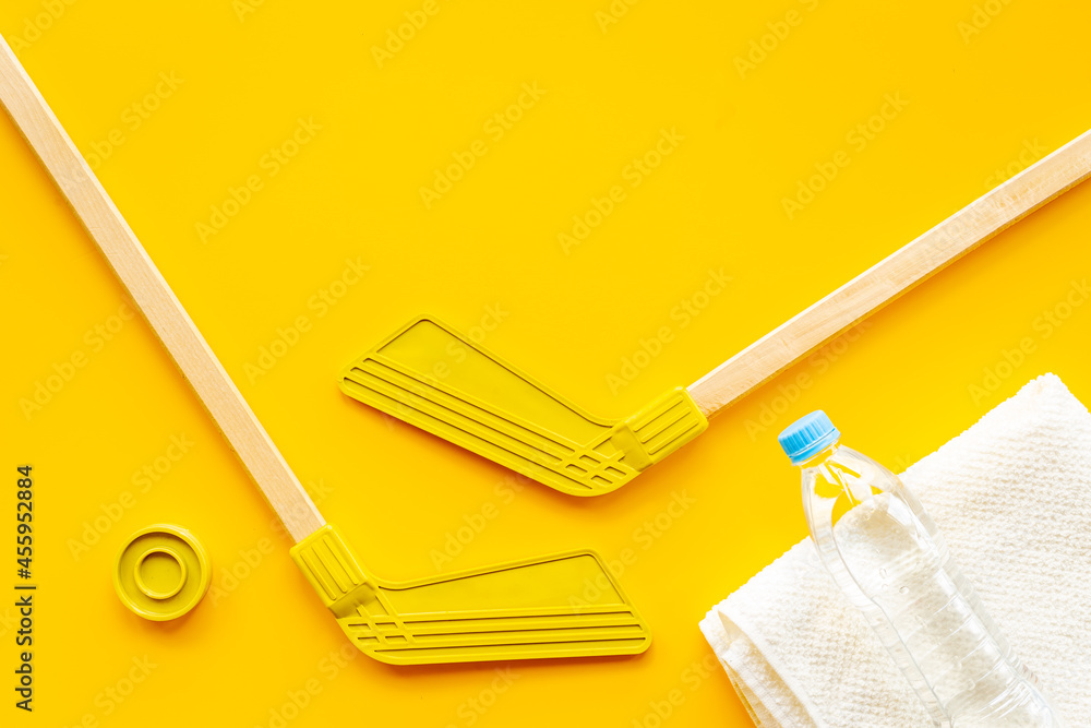 Competitive sports equipment with hockey sticks towel and bottle of water. Top view Competitive sports equipment with hockey sticks towel and bottle of water. Top view