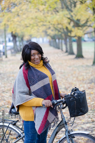 Portrait smiling, confident senior woman bike riding in autumn park