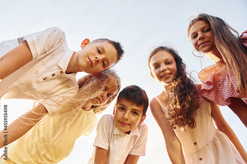 View from below of group of kids that looking down and having fun