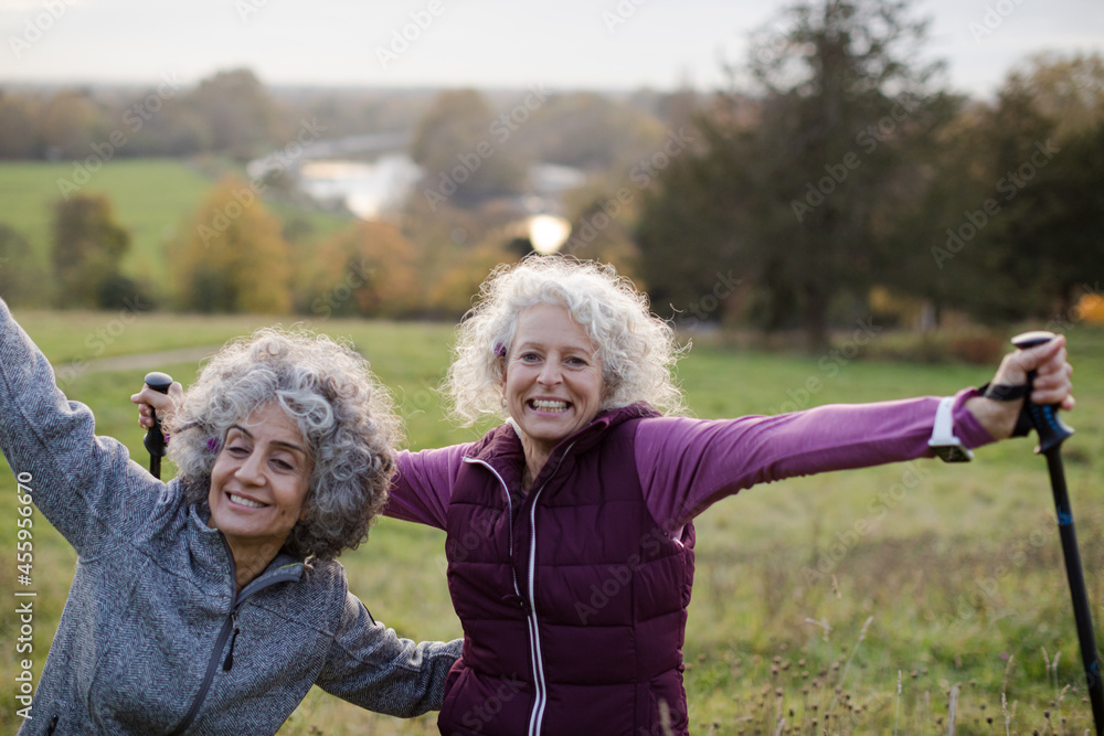 Portrait smiling, happy active senior women friends with walking sticks Portrait smiling, happy active senior women friends with walking sticks