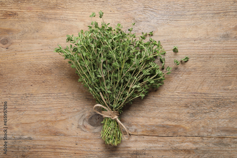Bunch of aromatic thyme on wooden table, top view Bunch of aromatic thyme on wooden table, top view