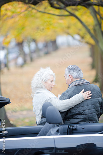 Affectionate, tender senior couple hugging in autumn park near car © KOTO