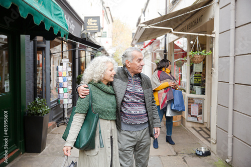 Senior couple window shopping in alley