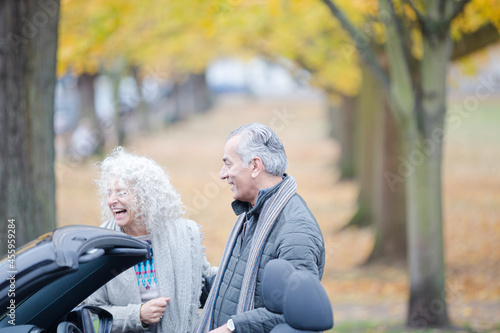 Affectionate, tender senior couple hugging in autumn park near car © KOTO