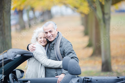 Affectionate, tender senior couple hugging in autumn park near car © KOTO