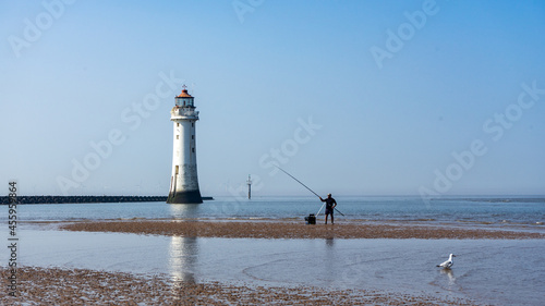 An angler at the low tide of the Irish Sea