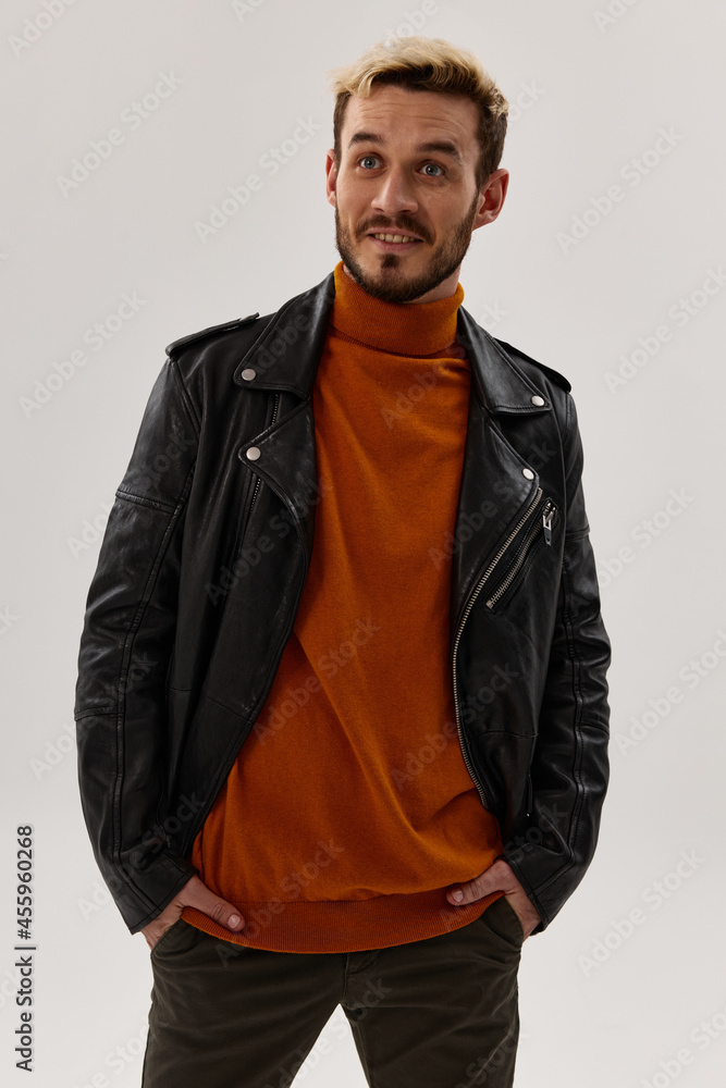 happy man with beard and leather jacket orange sweater pants model happy man with beard and leather jacket orange sweater pants model