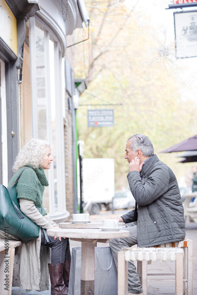 Senior couple drinking coffee at sidewalk cafe Senior couple drinking coffee at sidewalk cafe