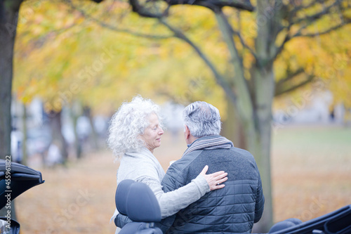 Wallpaper Mural Affectionate, tender senior couple hugging in autumn park near car Torontodigital.ca