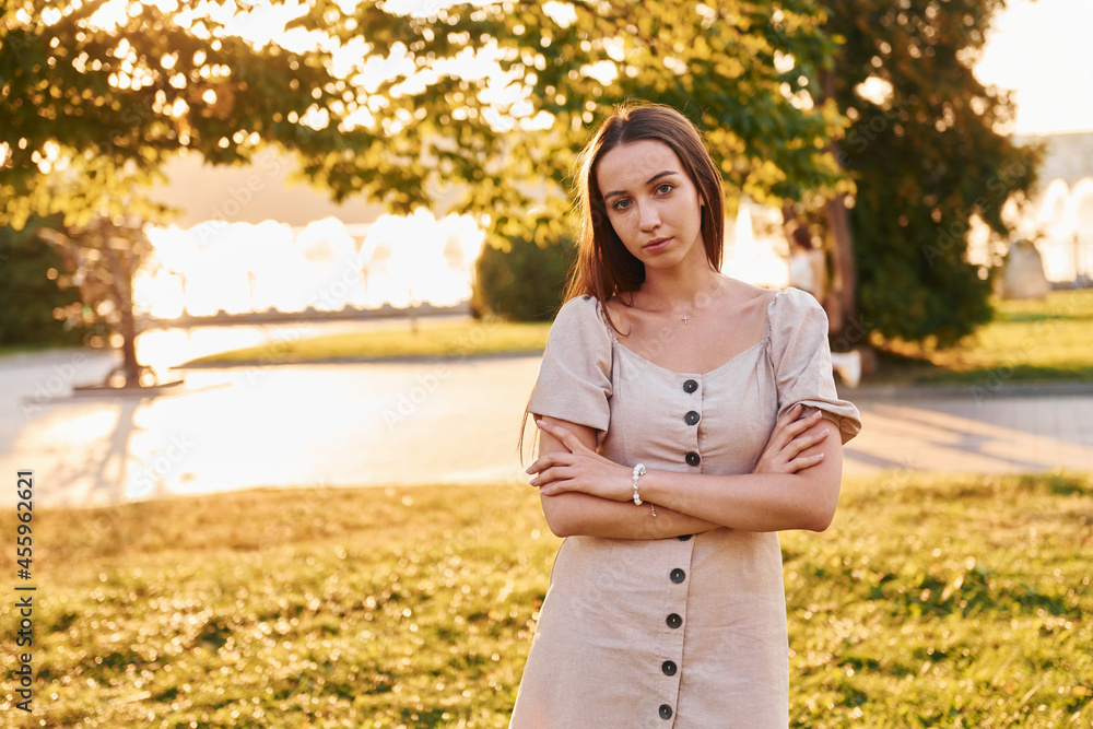 Woman standing in the autumn park. Beautiful sunshine