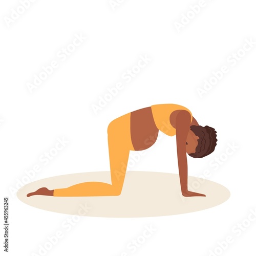 Cat Pose. Pregnant African American woman doing yoga. Woman in sportswear doing floor exercises on mat. Women healthy life style concept. Active lifestyle and baby health care. Prenatal Marjariasana. photo
