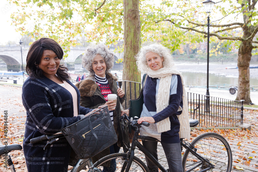 Portrait confident, smiling senior women bike riding in autumn park Portrait confident, smiling senior women bike riding in autumn park