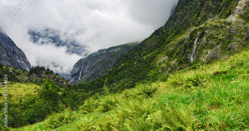 Vászonkép Wild alpine landscape with two waterfalls at a cloudy day in summer