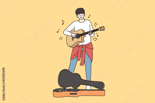 Street performance and begging concept. Young happy male guitarist cartoon character standing busking by playing guitar in city singing song vector illustration 