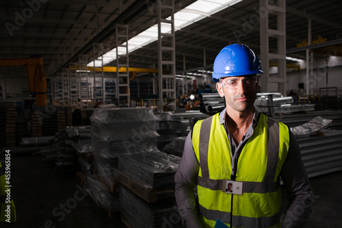 Portrait serious male worker in protective eyewear and hard-hat in factory © KOTO