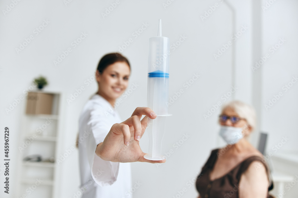 Nurse giving an injection to an elderly woman vaccination immunity protection Nurse giving an injection to an elderly woman vaccination immunity protection