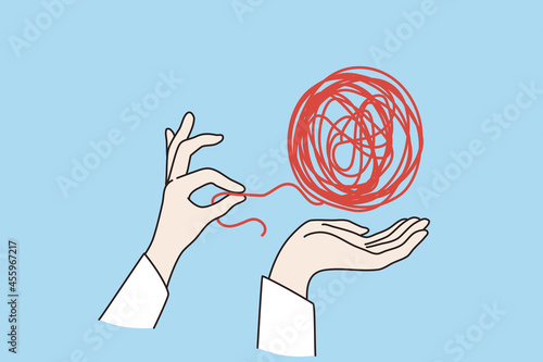 Psychotherapy and mental health concept. Human hand untangling red dirty knot snarl over blue background vector illustration 