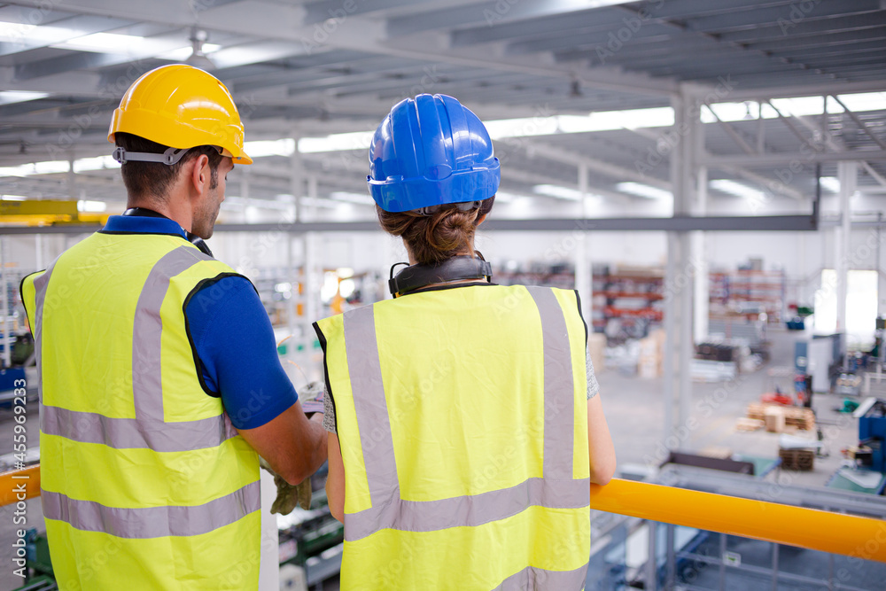 Supervisor and worker talking in steel factory Supervisor and worker talking in steel factory