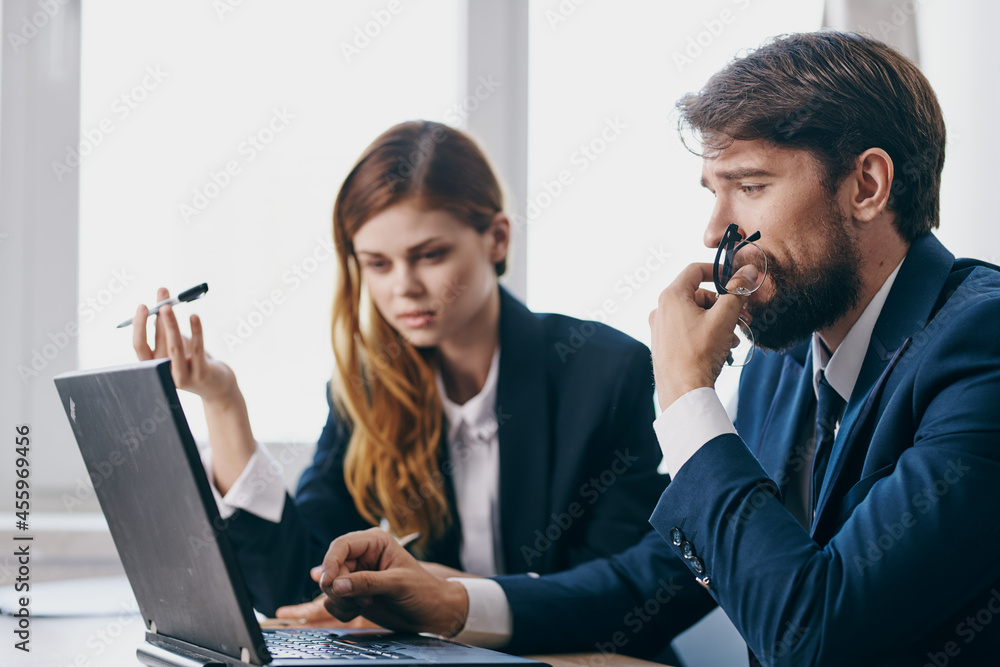 business man and woman sitting in front of a laptop teamwork technologies business man and woman sitting in front of a laptop teamwork technologies