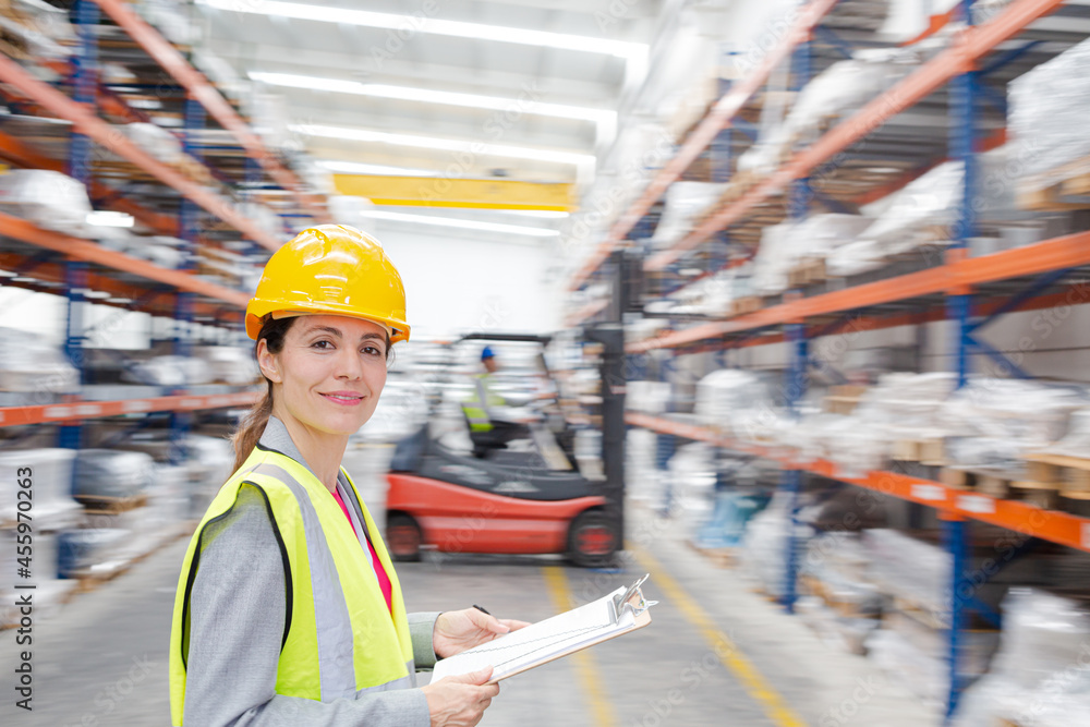 Portrait confident female supervisor with clipboard in warehouse Portrait confident female supervisor with clipboard in warehouse