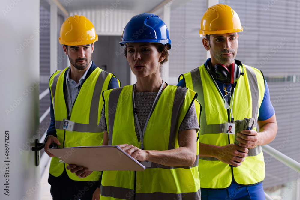 Supervisors and worker with clipboard in factory Supervisors and worker with clipboard in factory