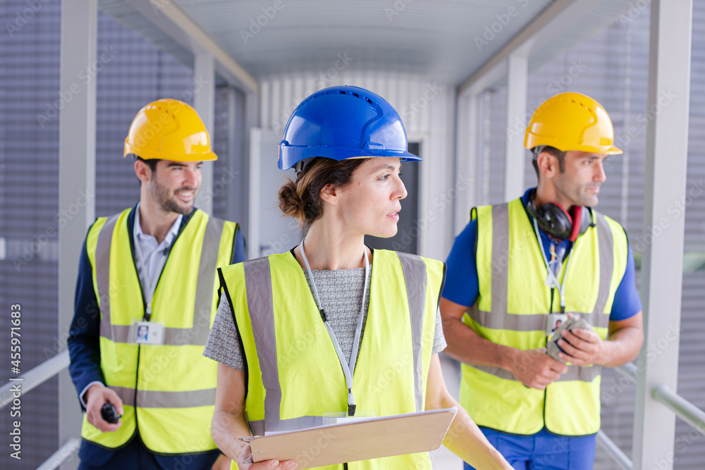 Supervisors and worker with clipboard in factory Supervisors and worker with clipboard in factory