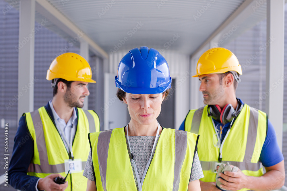Supervisors and worker with clipboard in factory Supervisors and worker with clipboard in factory