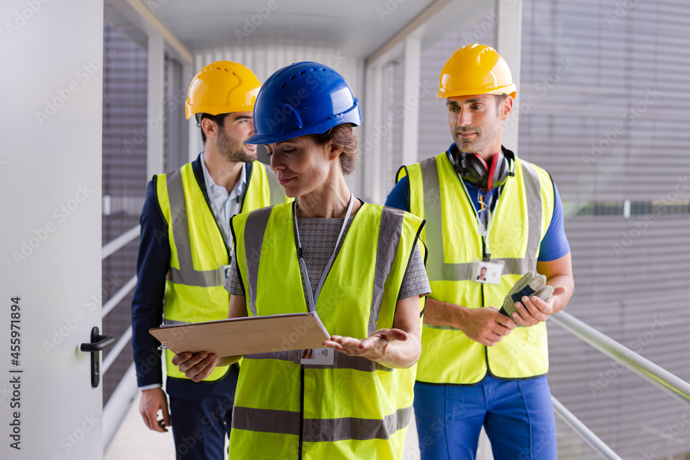 Supervisors and worker with clipboard in factory Supervisors and worker with clipboard in factory