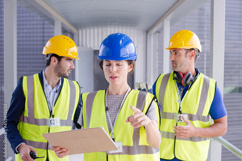 Supervisors and worker with clipboard in factory Supervisors and worker with clipboard in factory
