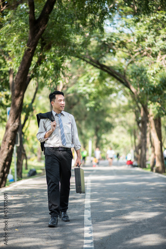 Young businessman with a briefcase in the park © ic36006