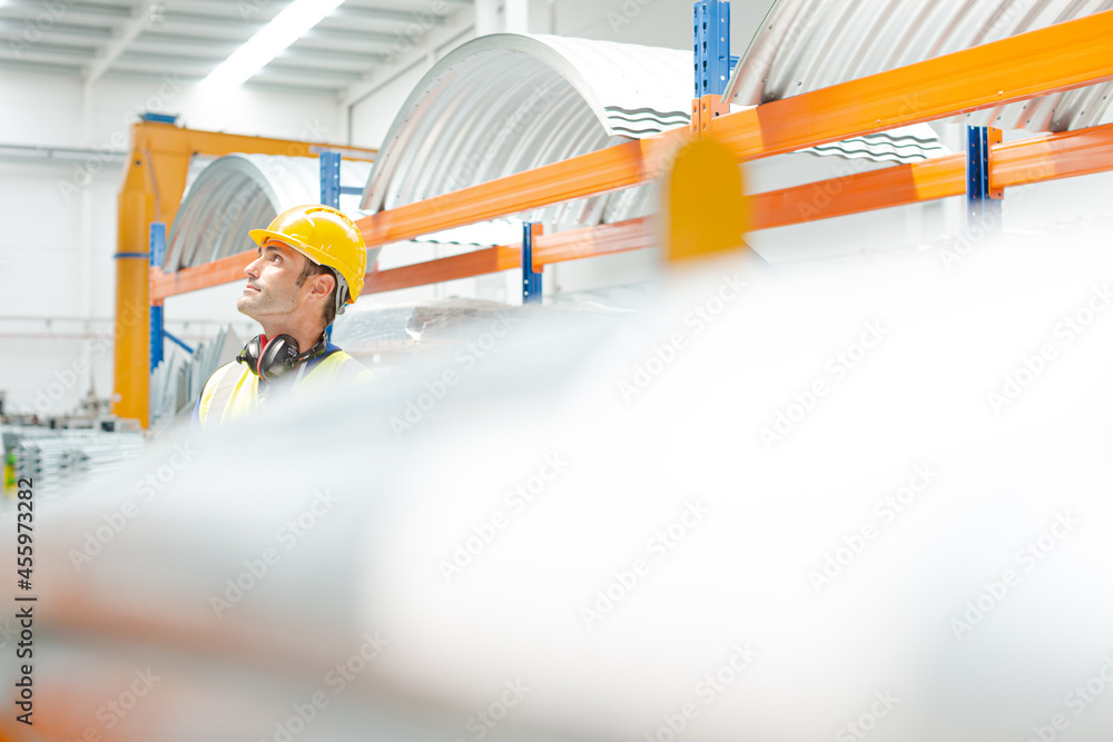 Naklejka premium Male worker looking up in factory