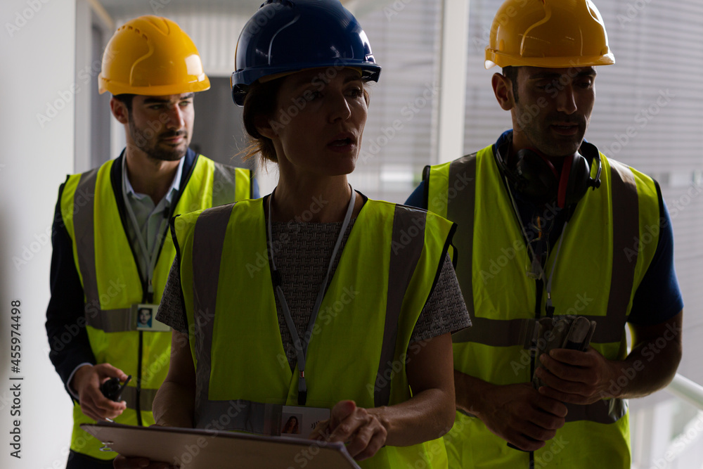 Supervisors and worker with clipboard in factory Supervisors and worker with clipboard in factory