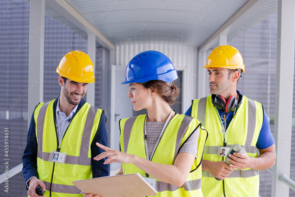 Supervisors and worker with clipboard in factory Supervisors and worker with clipboard in factory