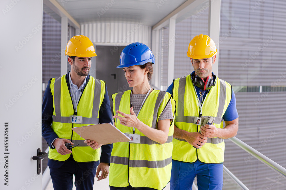 Supervisors and worker with clipboard in factory Supervisors and worker with clipboard in factory