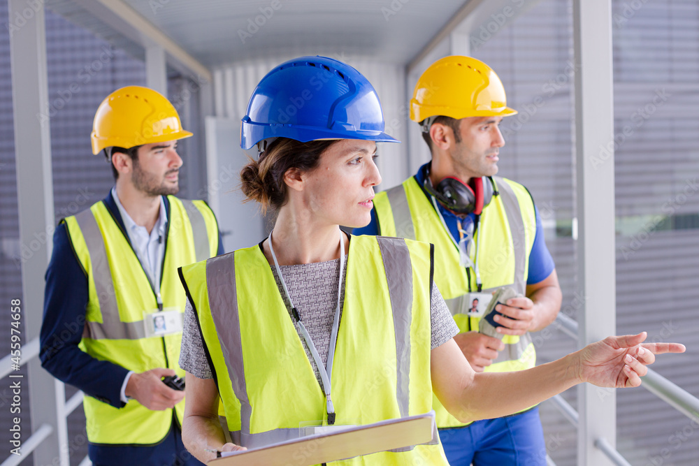 Supervisors and worker with clipboard in factory Supervisors and worker with clipboard in factory