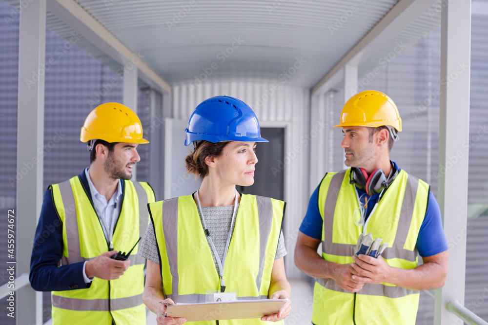 Supervisors and worker with clipboard in factory Supervisors and worker with clipboard in factory