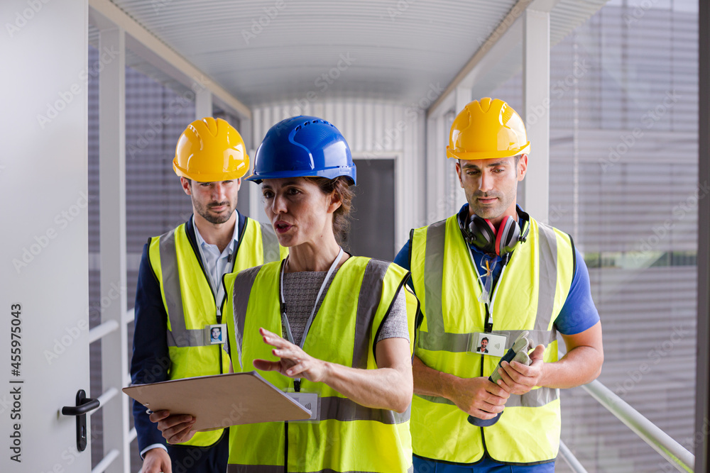 Supervisors and worker with clipboard in factory Supervisors and worker with clipboard in factory