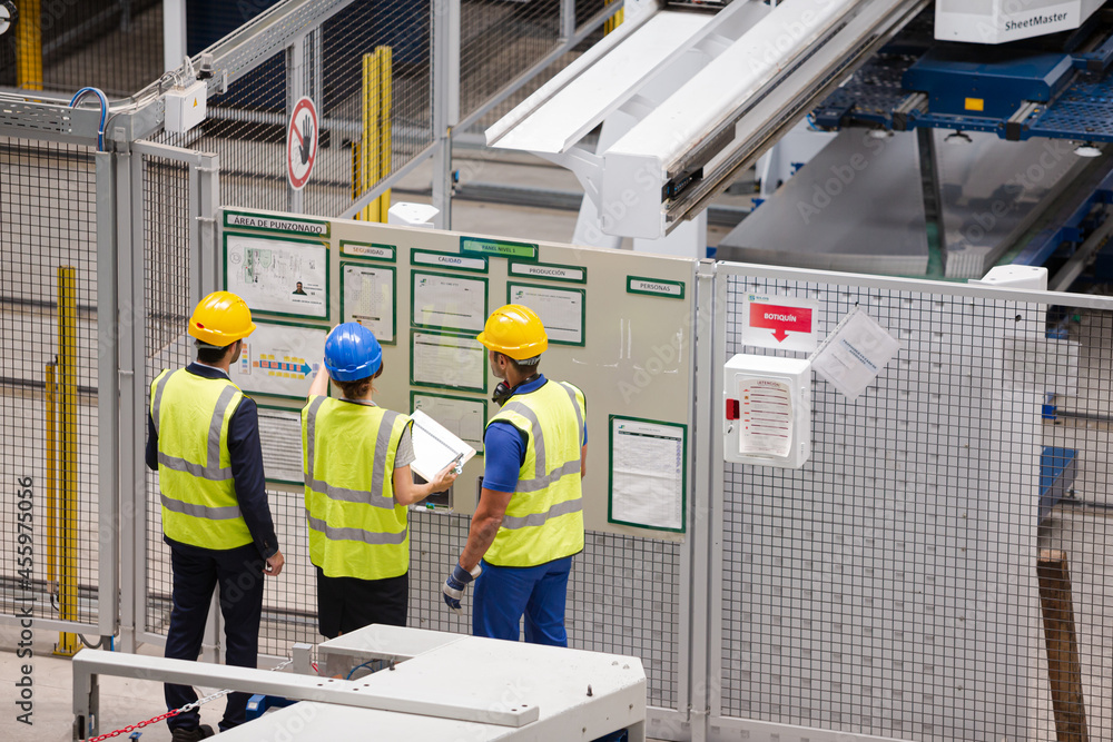 Supervisor and workers talking in factory Supervisor and workers talking in factory