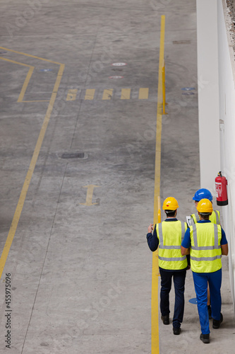 Supervisor and workers walking in factory