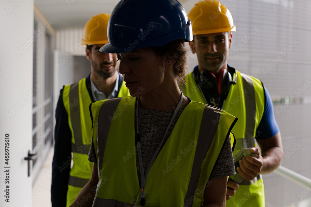 Supervisors and worker with clipboard in factory Supervisors and worker with clipboard in factory