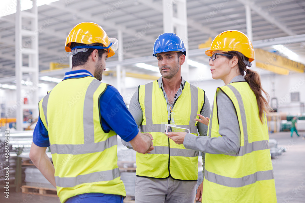 Supervisor and workers talking in steel factory Supervisor and workers talking in steel factory