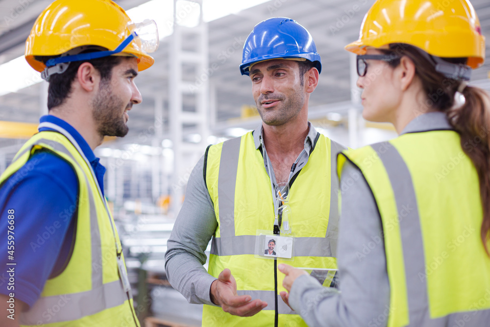 Supervisor and workers talking in steel factory Supervisor and workers talking in steel factory