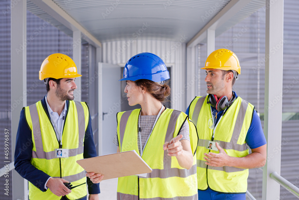 Supervisors and worker with clipboard in factory Supervisors and worker with clipboard in factory